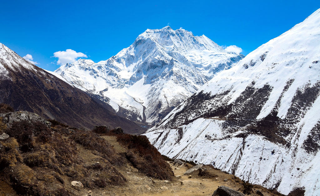 A panoramic embrace of nature's artistry: the Manaslu horizon merges sky, mountain, and valley into a canvas of awe-inspiring beauty.