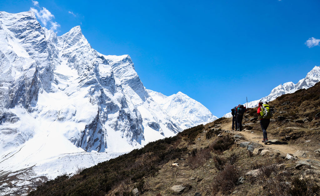 Walking against the backdrop of the world's eighth highest peak, trekkers embrace the breathtaking harmony of the Manaslu region.