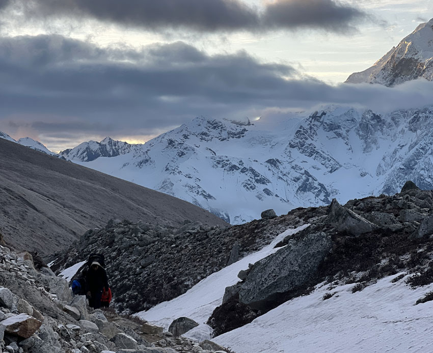 Trekkers climbing from Dharmasala towards Larkya La Pass on the Manaslu Circuit Trek