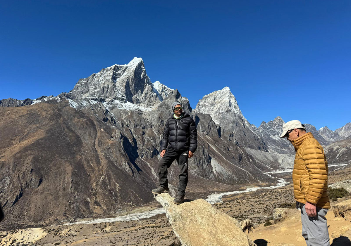 Local Everest trekking guide with Indian trekkers enjoying mountain views on the Everest Base Camp Trek