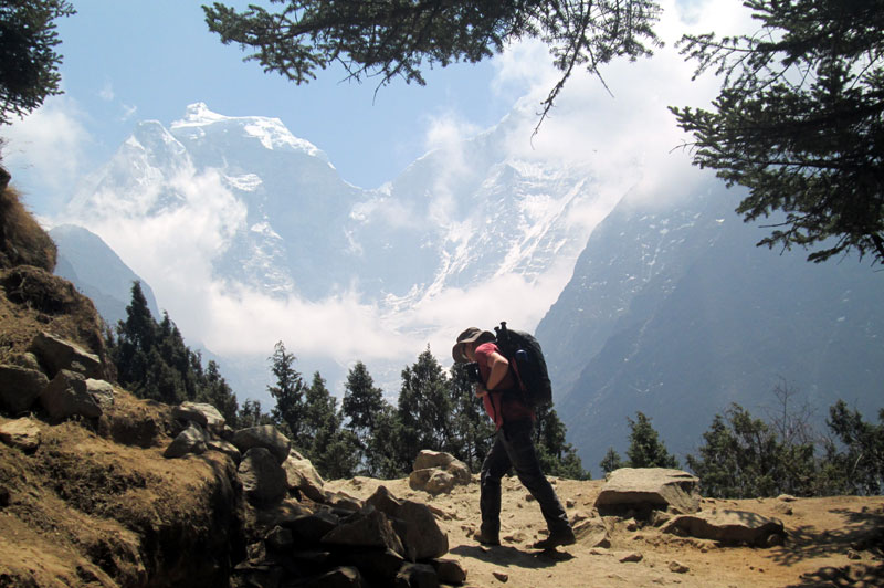 Trekkers walking above Namche Bazaar during a winter Everest Base Camp Trek with Himalayan mountain views