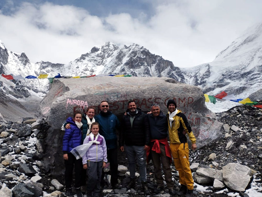 Trekkers and guide trekking to Everest Base Camp during monsoon season