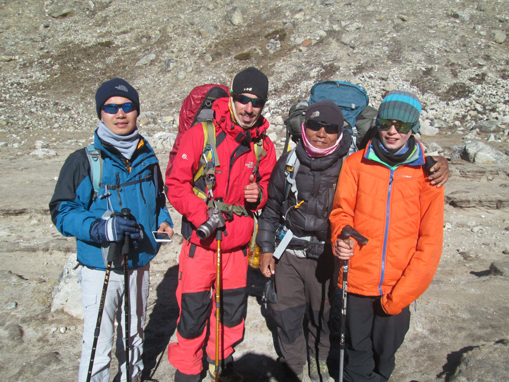 Everest guide and porter supporting trekkers on the Everest Base Camp route