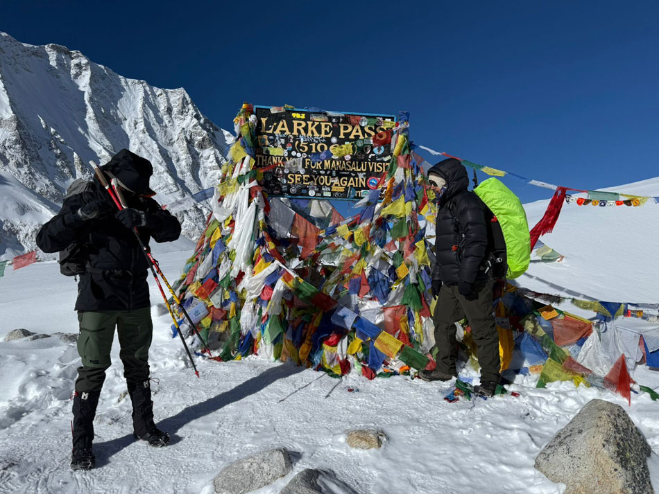 Trekkers crossing Larkya La Pass on the Manaslu Circuit and Tsum Valley Trek