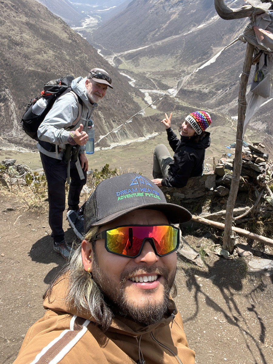 Local Manaslu circuit trekking guide leading trekkers through a Himalayan village