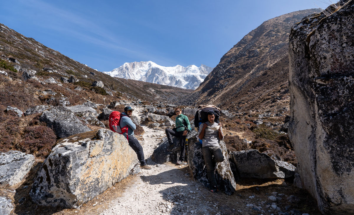 Experienced Manaslu trekking guide and porter assisting trekkers during the journey