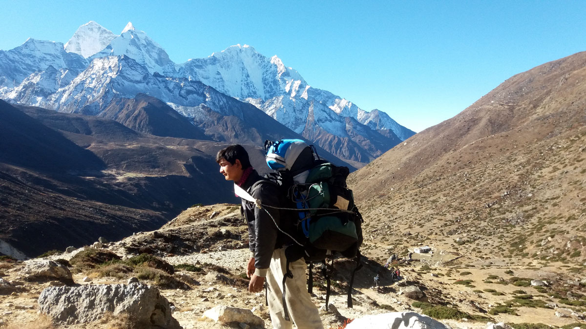 Porter carrying trekking gear on the Everest Base Camp route
