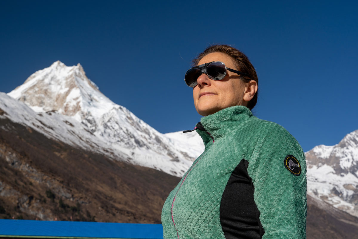 Female trekker with Mount Manaslu in the background