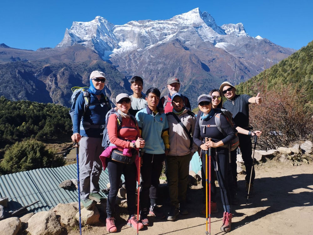 Guide and porter supporting trekkers on the Everest Base Camp trek